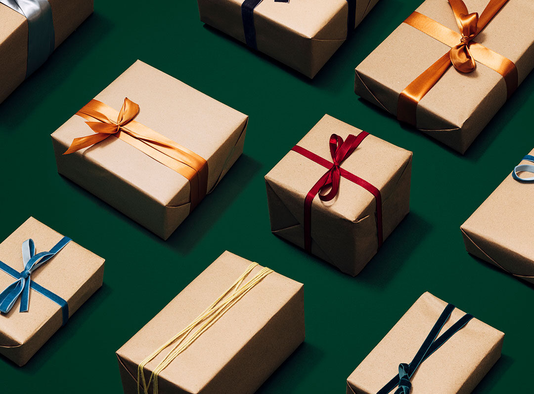 Close Up Photo of Many Different Christmas Presents on a Green Background